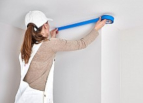 przyklejanie niebieskiej taśmy malarskie